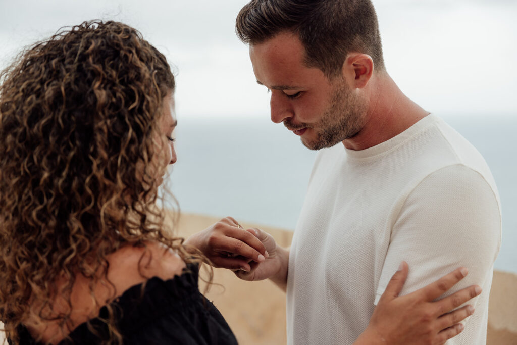 Couple celebrating engagement with portraits at Alicante castle
